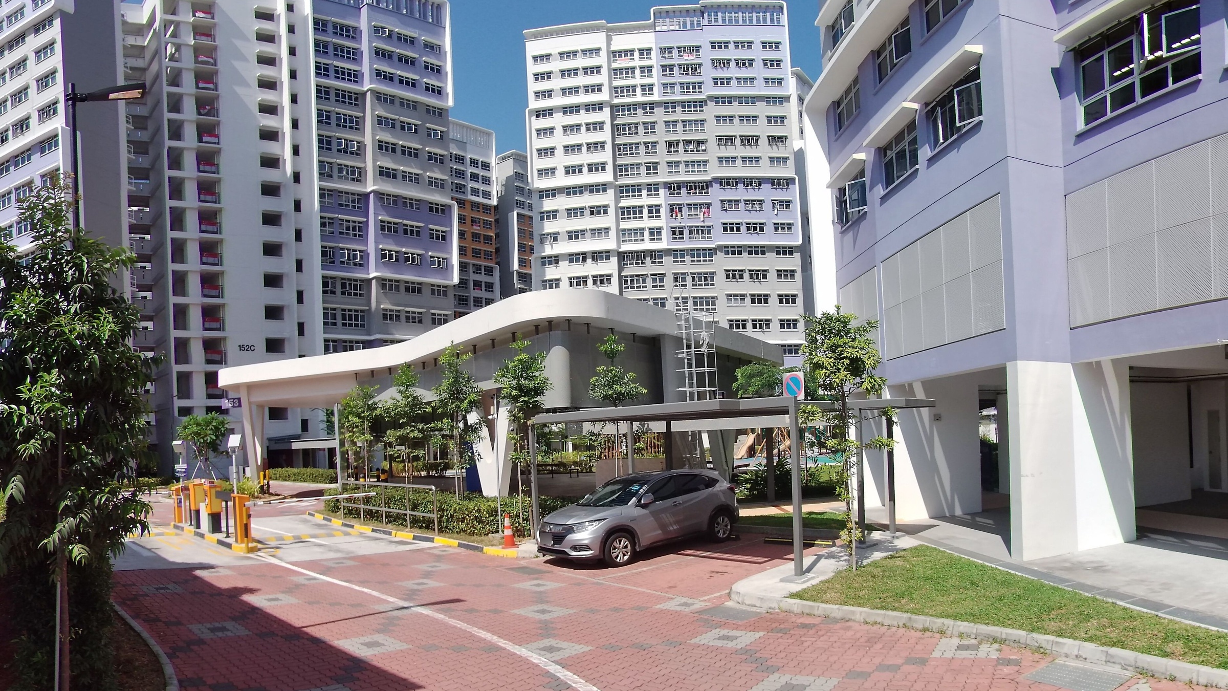 The lavender and white towers of Bedok South Horizon at Bedok South Road, with the block 152C and 153 signs visible at the carpark entrance