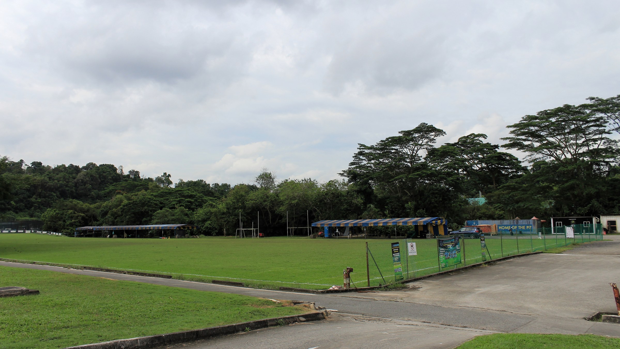 Open sports fields and low buildings on the former Turf City site in Bukit Timah.