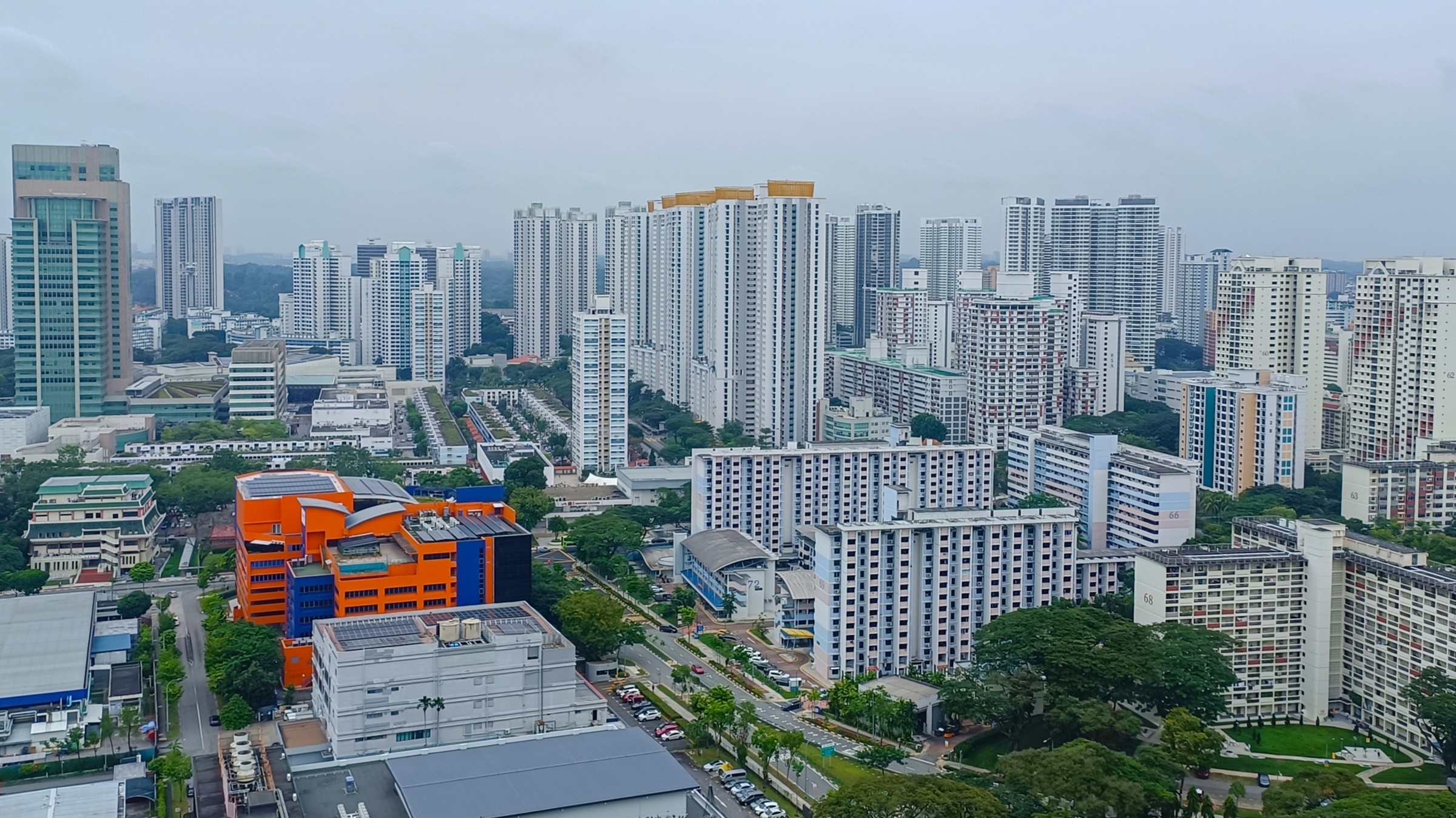 Aerial view of high-rise private condominiums and HDB blocks across a Singapore residential district.