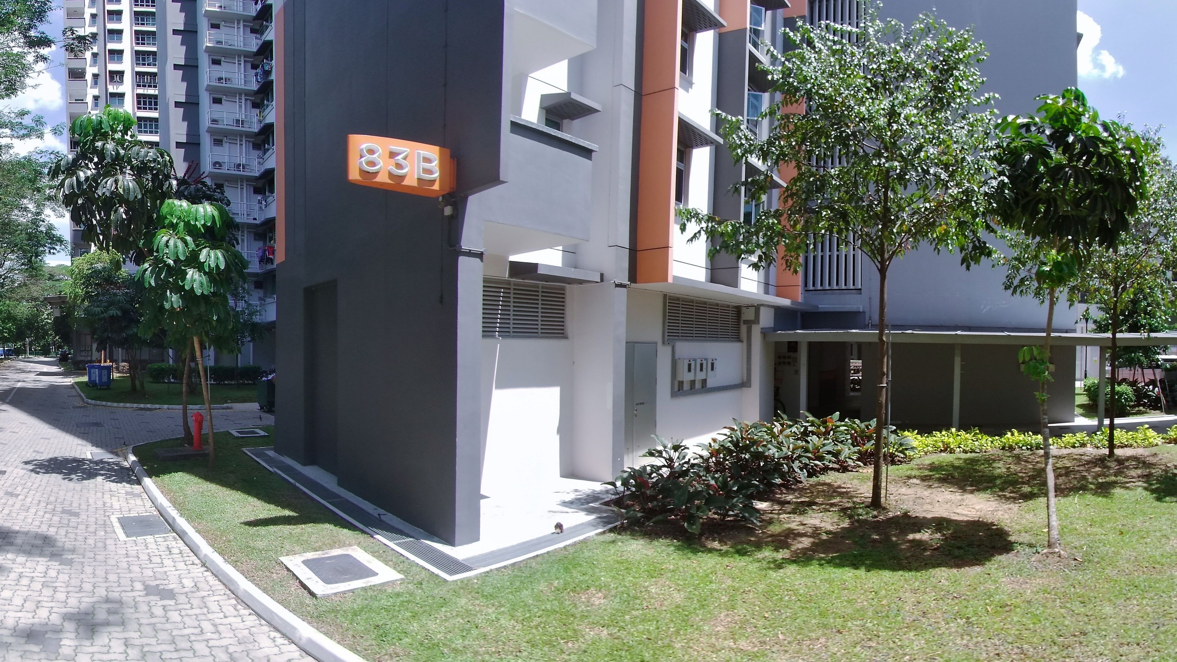 Block 83B of MacPherson Spring on Circuit Road, with its orange block sign and grey-and-orange facade