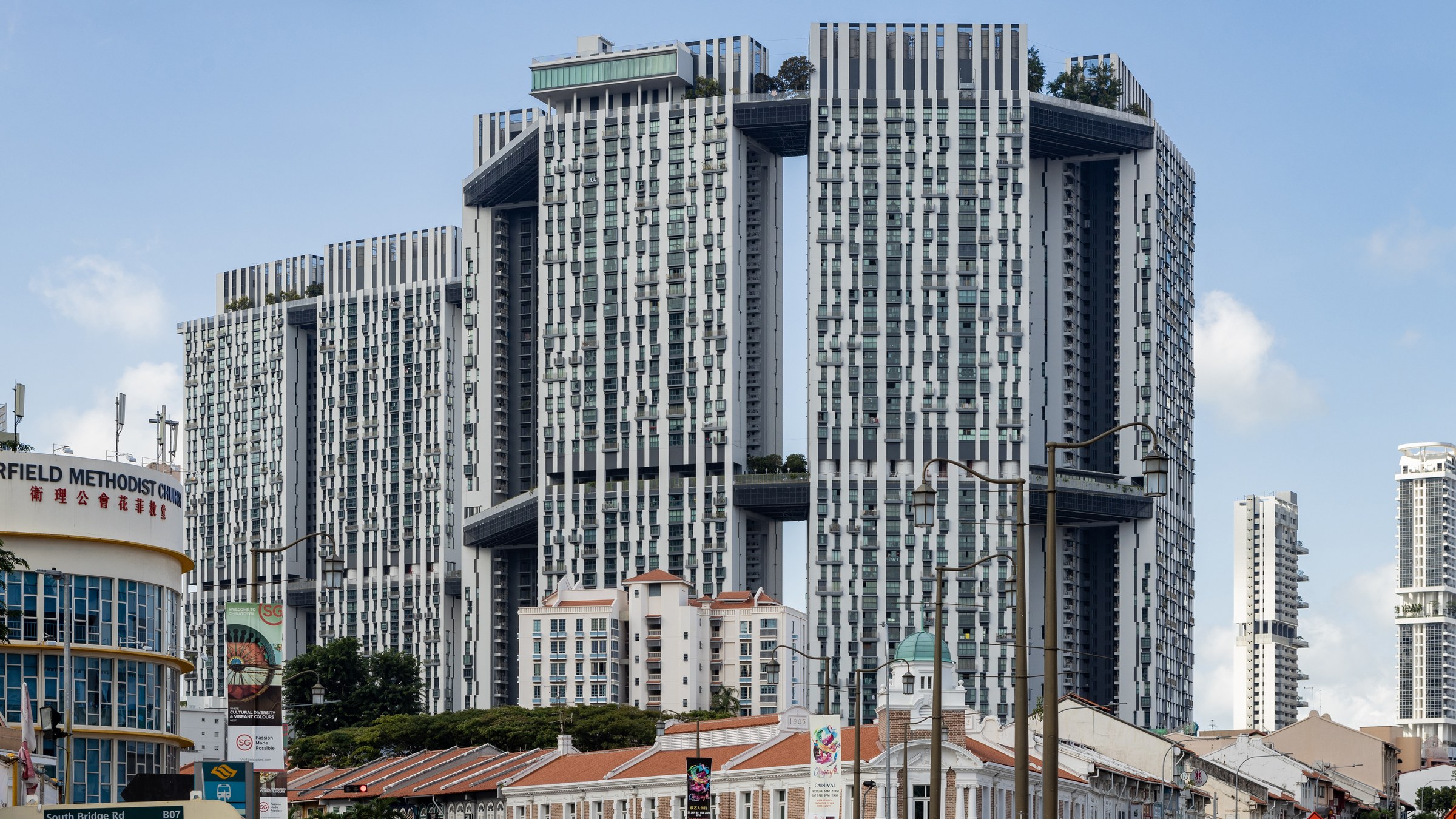 The Pinnacle@Duxton's linked towers rising above the Tanjong Pagar shophouses