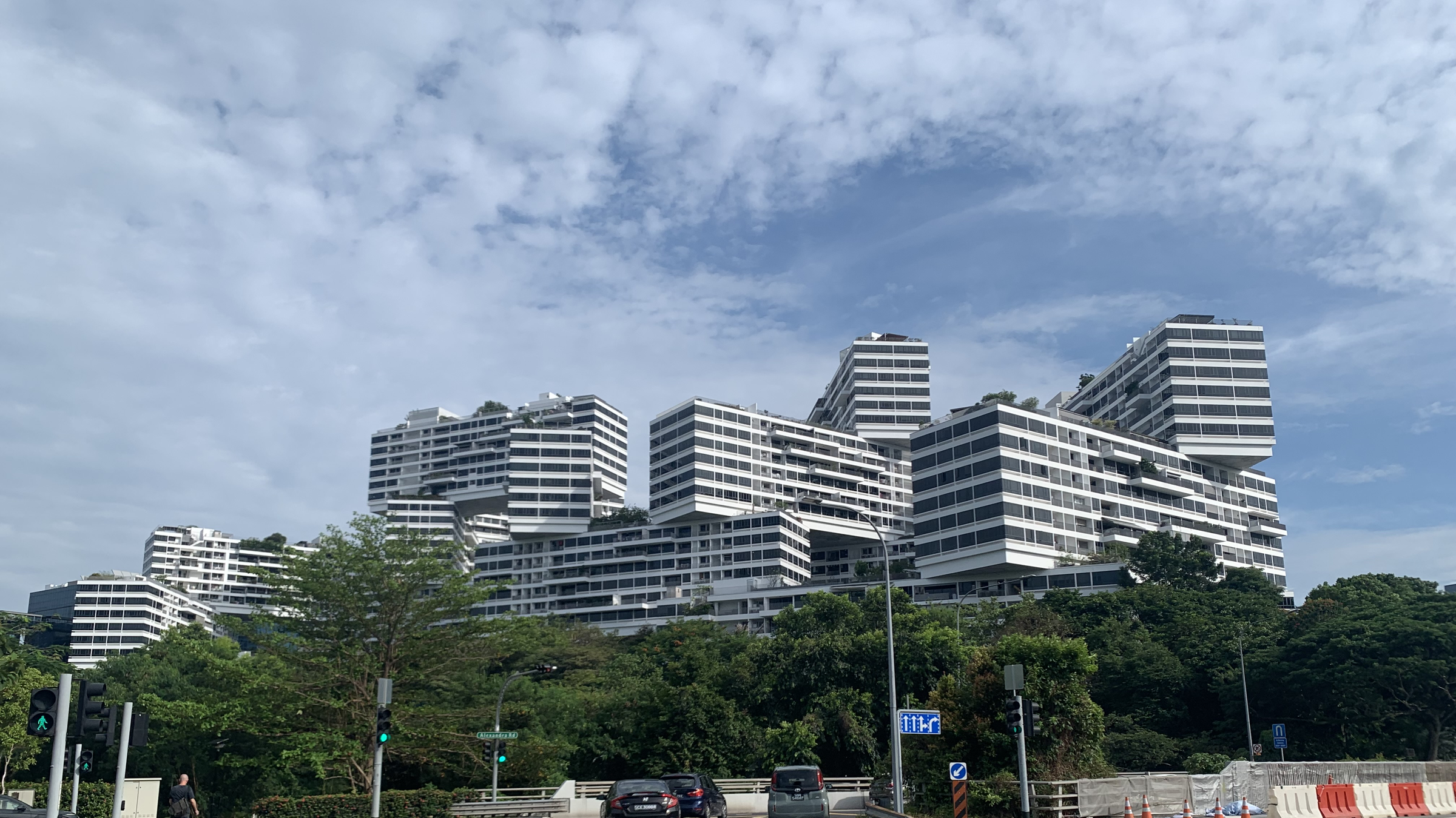 The stacked, interlocking blocks of The Interlace condominium in Alexandra, Singapore, seen from Alexandra Road under a blue sky